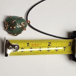 Handmade wire wrap stone pendant with cord.